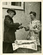 Dave McConnell selling a fish, c. 1935