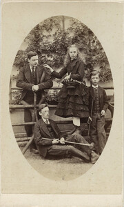[Photograph depicting a family with croquet mallets]