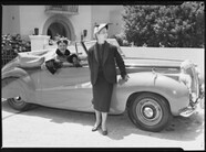 Two fashion models in front of an open top car, Sydney c. 1948