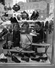 Unidentified young women window shopping at Turner's store in Tallahassee, Florida
