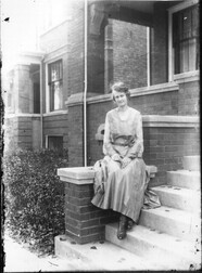 Woman on porch steps n.d.