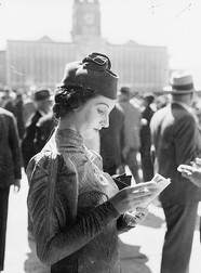 Woman reading the race guide, Sydney Cup, Randwick Racecourse, March 1937, by Sam Hood