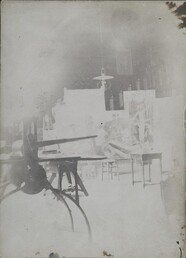 Interior of Kalela featuring individual paintings from Akseli Gallen-Kallela's Kalevala and an etching press in the foreground