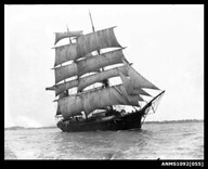 Three-masted barque underway with sails set, possibly Sydney Harbour