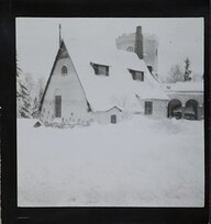 Winter-time view of TarvaspÃ¤Ã¤, photographed from the south-west. The picture features the building's roofs and its characteristic central tower and entrance archway
