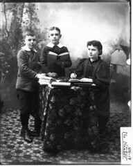 Children around a table with books n.d.