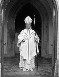 Rev. Cornelius Claffey, at church entrance, full-length portrait