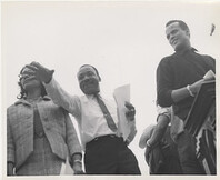 Martin Luther King, Jr. and Harry Belafonte near podium at Montgomery March