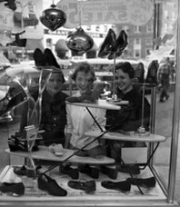Unidentified young women window shopping at Turner's store in Tallahassee, Florida