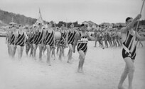 Surf lifesavers march past Burleigh Heads ca. 1935