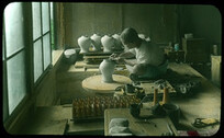 Potter making vase on wheel.