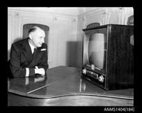 Man watching an AWA television on board the ship TAIPING