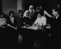 A female immigrant piecing together a wooden puzzle as part of an examination