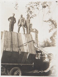 Studies for the Kalevala frescoes ready to be transported from TarvaspÃ¤Ã¤ to the National Museum of Finland; Akseli and Jorma Gallen-Kallela and YrjÃ¶ Lampila staying on the load, 1928; print 2 of the photograph.