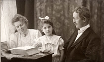 Portrait of a family seated by the window