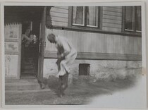 Akseli Gallen-Kallela jumping with a pogo stick in front of Gallen-KallelasÂ´ home in Porvoo, 1923.