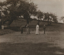 [Photograph depicting men and women playing croquet]
