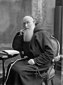 Rev. Paul seated, three-quarter length portrait