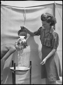Boy getting his hair washed, Narrabeen camp, 26 January 1944, by Alec Iverson