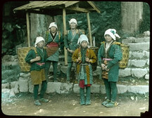 Rural women in local attire carrying large baskets on their backs.