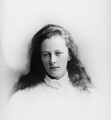 Young girl in high collared white blouse