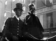 Man and woman in vehicle passing 102-103 Grafton Street