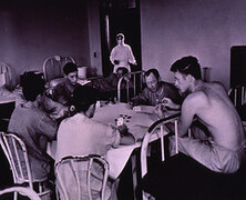 Men playing cards in quarantined area