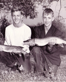Two Young Men Holding Fish