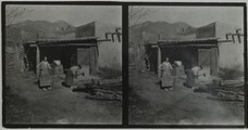 Mary Gallen-Kallela cutting wood with daughter Kirsti watching at home in Taos, New Mexico, ca.1925.