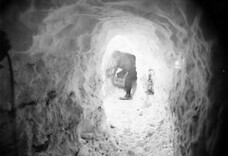 Xavier Mertz Bringing in a box of Ice through the Catacombs, Antarctica,  1912, by Frank Hurley