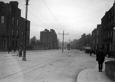 Pedestrians , motor cars and trams on Baggot Street, Dublin
