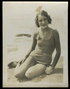 Photograph of a young woman sitting on the sand