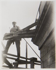 Akseli Gallen-Kallela at TarvaspÃ¤Ã¤Â´s tower working on a dragon-shaped gargoyle, 1927; photograph 1.