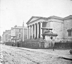"Large public building, railings, steps, 6 columns in portico, 2 guns on plinths, one plinth inscribed India" is Tralee Courthouse
