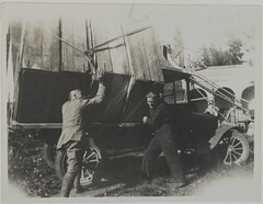Studies for the Kalevala frescoes ready to be transported from TarvaspÃ¤Ã¤ to the National Museum of Finland, Akseli Gallen-Kallela with another man by the car, 1928. Print 1 of the picture 1.