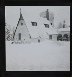 Winter-time view of TarvaspÃ¤Ã¤, photographed from the south-west. The picture features the building's roofs and its characteristic central tower and entrance archway