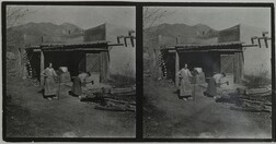 Mary Gallen-Kallela cutting wood with daughter Kirsti watching at home in Taos, New Mexico, ca.1925.