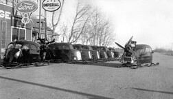 Line of early snow mobiles