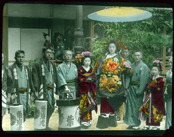 People in special attire, with lanterns, posing for photograph.