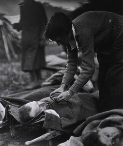 U.S. Army Evacuation Hospital Nos. 6 & 7, Souilly, France, Red Cross worker Miss Anna Rochester, of the Smith College Unit, feeding wounded soldier through a tube