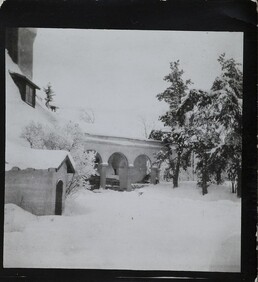 South-west view of TarvaspÃ¤Ã¤ during the winter, featuring the building's west-facing roof and archway