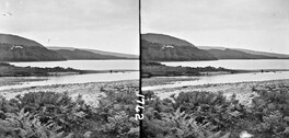 Tidal waters and tree-covered hills.