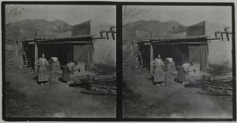 Mary Gallen-Kallela cutting wood with daughter Kirsti watching at home in Taos, New Mexico, ca.1925.