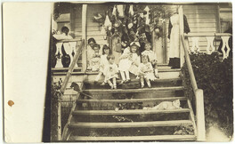 Children beside a Christmas tree (c1910s)