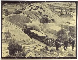Queenstown - Mt Lyell Mine - funeral procession drawn by Mt Lyell train with photographers in foreground (1912)