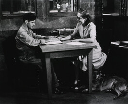 A blind woman teaching a blind man to read Braille