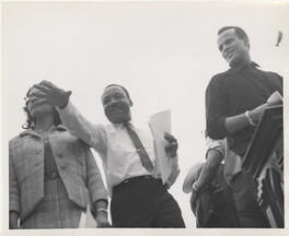 Martin Luther King, Jr. and Harry Belafonte near podium at Montgomery March