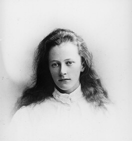 Young girl in high collared white blouse