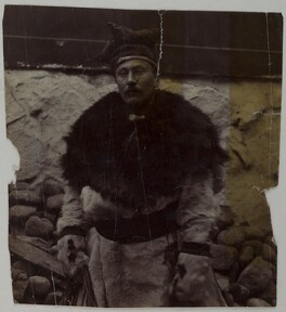 A man dressed in fur with a four winds hat on his head.