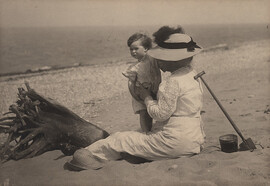 Woman with child at beach, date unknown